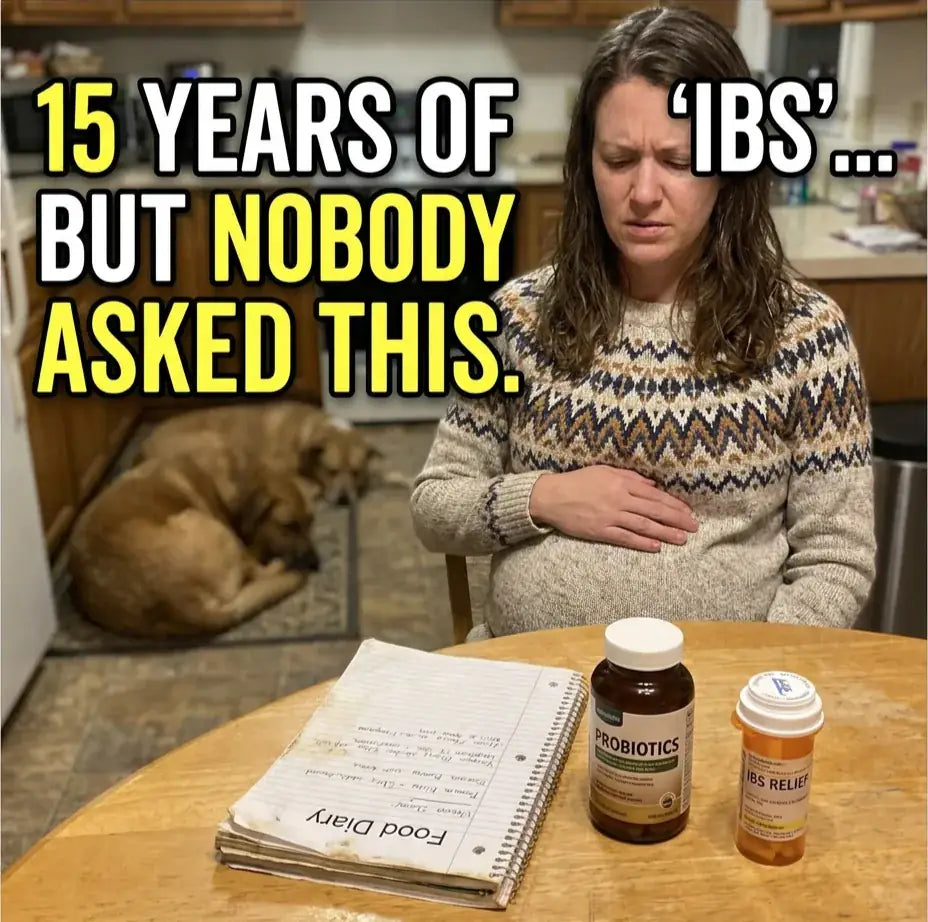 A woman resting her hand on her bloated stomach at the kitchen table next to a food diary and the supplements she has already tried, with the caption ‘15 years of IBS… but nobody asked this.’